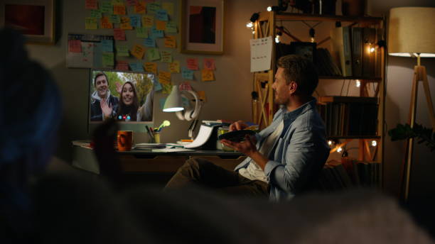 istock Cheerful friends talking web camera in evening. Young couple waving in screen 2155093242