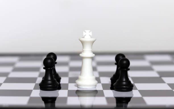 istock A white king object in the middle of a chess board. 2155094871