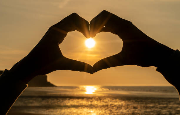Hand Heart Sunrise or Sunset on a beach