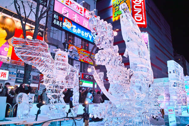 Sapporo, Hokkaido, Japan - February 9, 2024: Ice sculptures at the Susukino venue at night during the Sapporo Snow Festival. Many ice sculptures are displayed on the main street of Susukino.