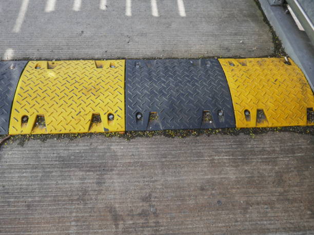 istock Speed bump painted black and yellow on road 2155098007