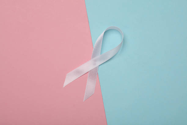 istock White awareness ribbon on pink blue background 2155099606