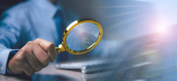 istock Businessman using magnifying glass searching data. Information in the internet world search technology Search Engine Optimization(SEO). 2155099732