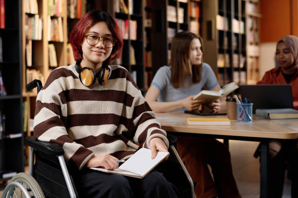 istock Asian Girl With Disability In College Library 2155101847