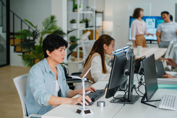 istock Dedicated employees, woman in wheelchair, work on solar energy projects, highlighting a business's commitment to sustainability and inclusive practices. ESG sustainable business office. 2155102828