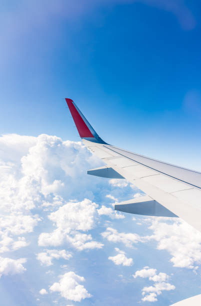 istock View from the airplane window at a beautiful cloudy sky and the airplane wing 2155104562