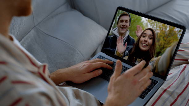 istock Smiling friends video calling online. Happy people enjoying web cam conference 2155104607