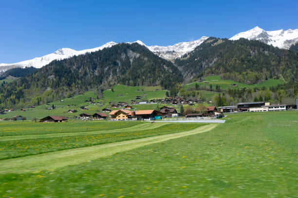 Hillside village in Interlaken Switzerland in the background is the Alps