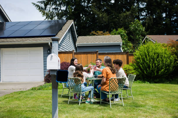 istock Family Enjoying Snack Outdoors in Front of Solar Equipped Home 2155104816