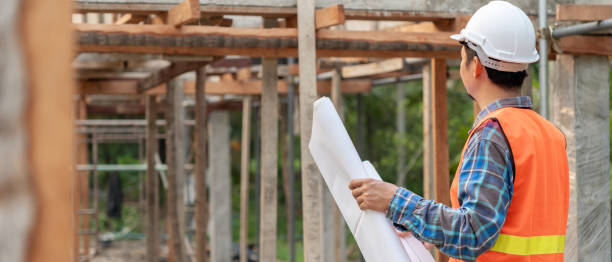 istock inspector or engineer is inspecting construction and quality assurance new house using a blue print. Engineer or architects or contactor work to build the house before handing it over to the homeowner 2155107718