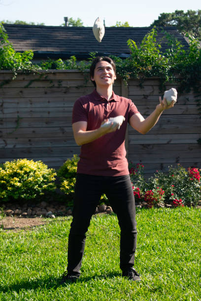 istock Young man jungles bean bags in backyard 2155108470