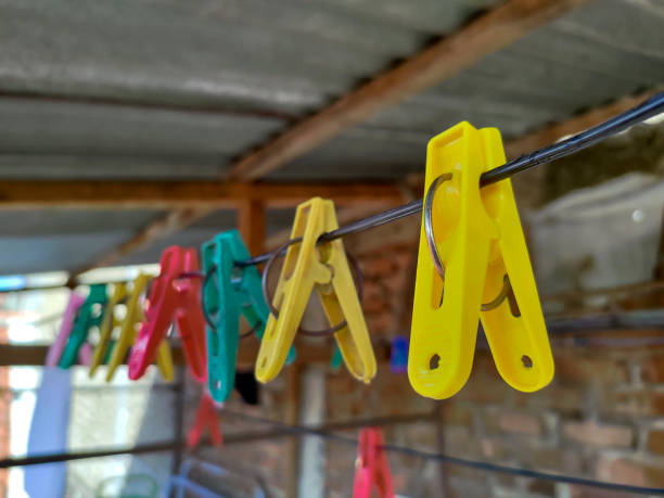Colorful clothespin hanging on the rope. Blurred background