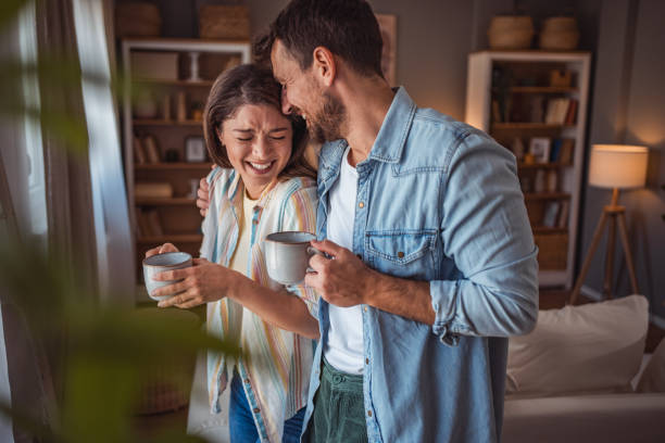 istock Happy couple drinking a cup of coffee at home 2155111666
