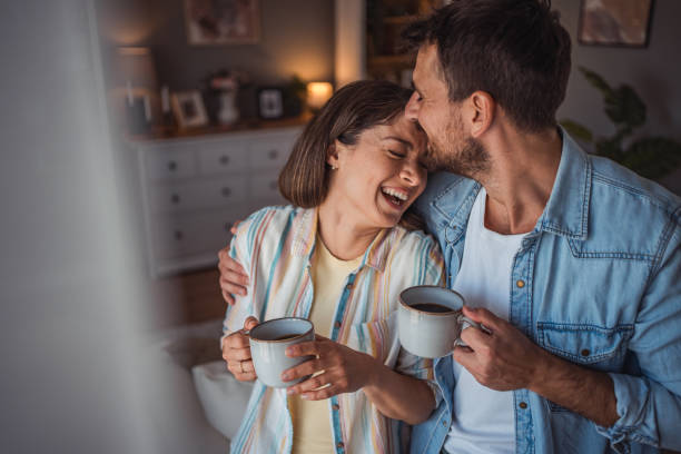 istock Happy couple drinking a cup of coffee at home 2155111707