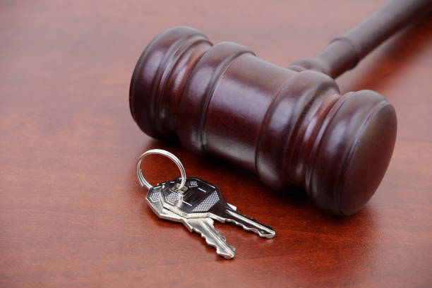 istock Judge gavel and keys on wooden table. 2155113784