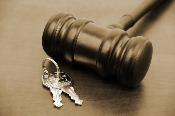 istock Judge gavel and keys on wooden table. 2155113856