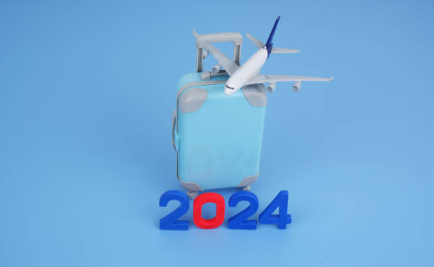 istock Airplane with suitcase and numbers 2024. 2155114753