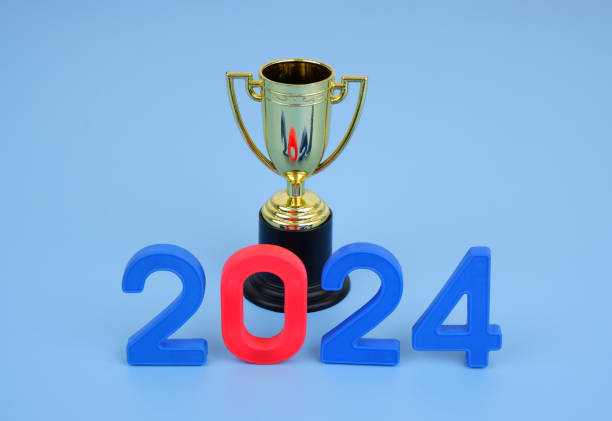 istock Golden champion cup and numbers 2024 on blue background. 2155114841