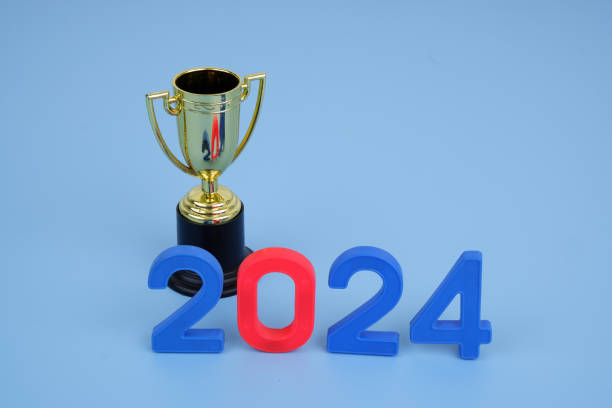 istock Golden champion cup and numbers 2024 on blue background. 2155114897
