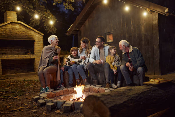 istock Happy multi-generation family enjoying by the bonfire at night. 2155115918