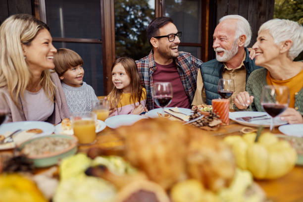 istock Happy extended family talking during a meal on a patio. 2155116233