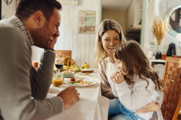 istock Happy family enjoying in lunch at dining table. 2155116264