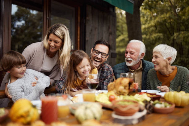 istock Cheerful multi-generation family having fun during a meal on a patio. 2155116491