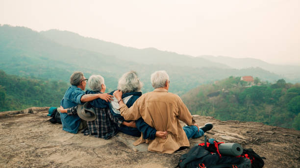 Happy multiracial senior  having fun together after hike on the mountain.