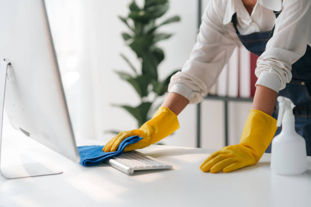 istock Housewife cleaning various equipment in the office. 2155118621