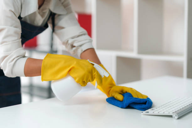istock Housewife cleaning various equipment in the office. 2155118625