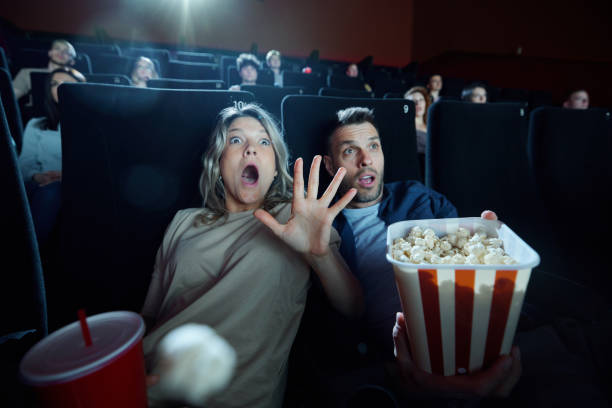 istock Watching a horror movie in cinema! 2155119288
