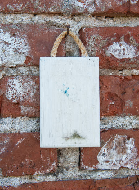 istock Old wooden blank signboard on the old aged brick wall background 2155119292