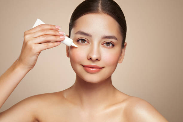 istock Beautiful woman using cream around the eye 2155119716