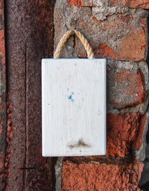 istock Old wooden blank signboard on the aged cement brick wall background 2155119793