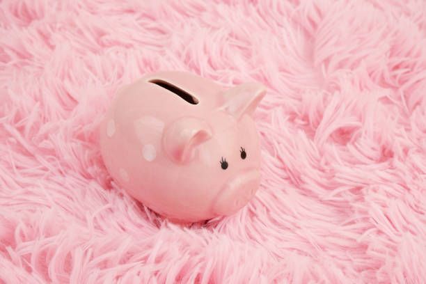A bright pink piggy bank with a cute face, perfect for saving money and teaching children the importance of saving.