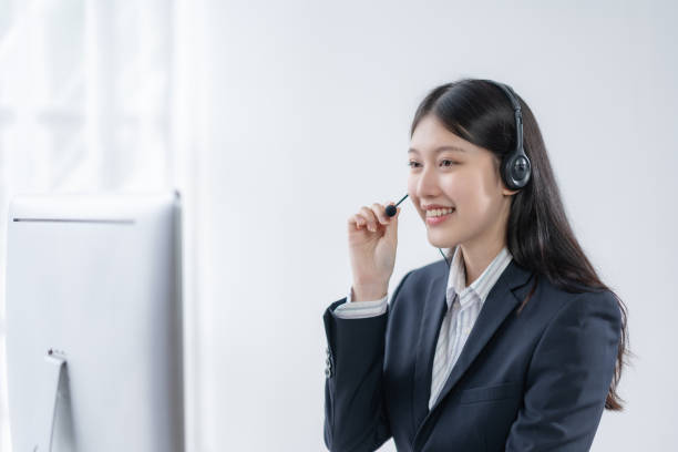 istock Asian Woman Operator Serving Customers Online 2155121769