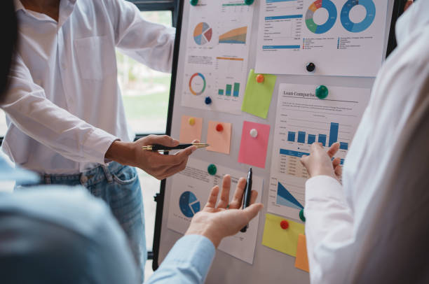 istock Meeting of hardworking businesspeople work together as a team by presenting graphs. and charting the work of each department, presenting and discussing the report together in the meeting. 2155121839