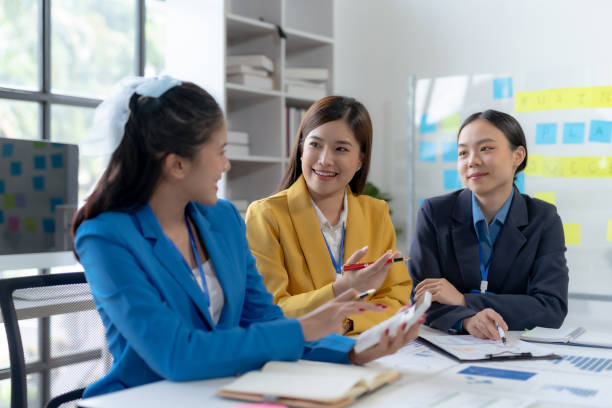 istock Creative asian business woman professionals planning a project in office. Teamwork and collaboration in a modern workplace. 2155122180