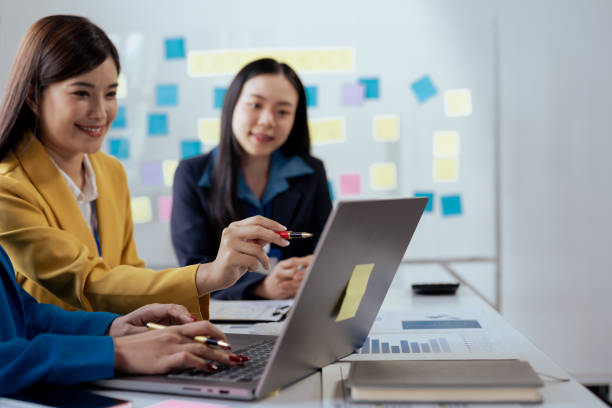 istock Creative asian business woman professionals planning a project in office. Teamwork and collaboration in a modern workplace. 2155122188