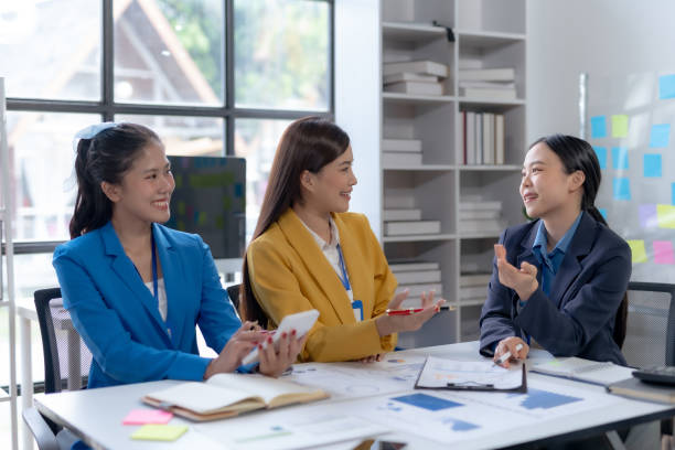 istock Creative asian business woman professionals planning a project in office. Teamwork and collaboration in a modern workplace. 2155122202