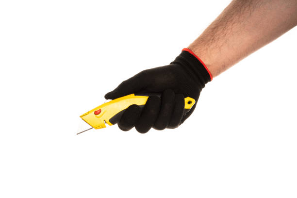 Segmented blade or snap-off blade utility knife in male hand isolated on white background.