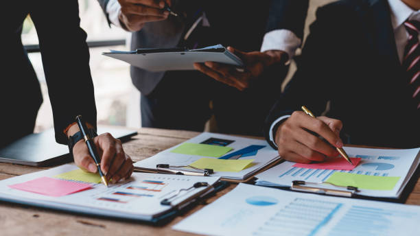 istock Groups of business people meeting to plan work with laptop computers, analyze graphs and corporate growth charts to plan future business expansions. 2155122774