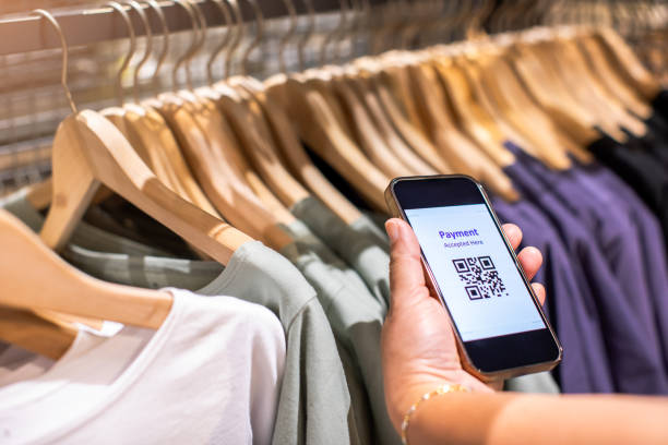 istock Selective focus to payment QR code tag on smartphone with blurry many clothes in the store to accepted generate digital pay without money. 2155123466
