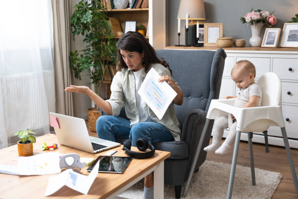 istock Young single divorced mother with baby using laptop computer for video call with her lawyer, talking about ex husband who not paying alimony and expenses and cost of living with small child. 2155124514