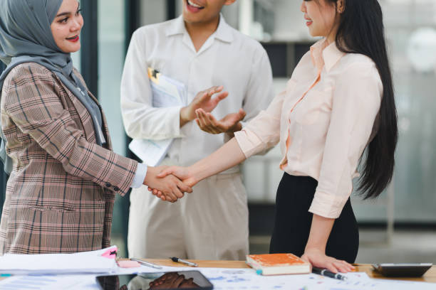 istock Business meeting between colleagues shaking hands in modern office. 2155125474