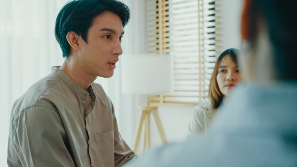 istock Group of psychotherapists talking and discussing mental health problems. People use group therapy to support each other in recovering from the sadness. 2155128401