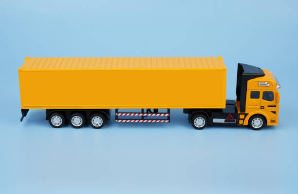 istock Yellow cargo truck on blue background. Copy space for text. 2155128559