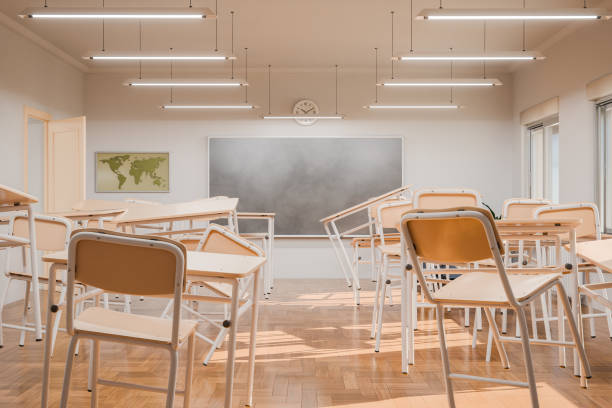 istock Disorganized Classroom with Floating Empty Desks and Chairs Indoors 2155128998