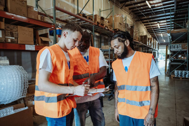 istock Factory with diverse employees having a meeting. Employees checking goods for delivery 2155129007