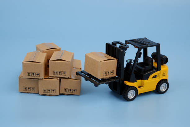 istock Forklift with many carton boxes on blue background. 2155129790